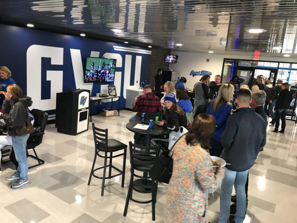 networking and watching the game on tv inside the fieldhouse